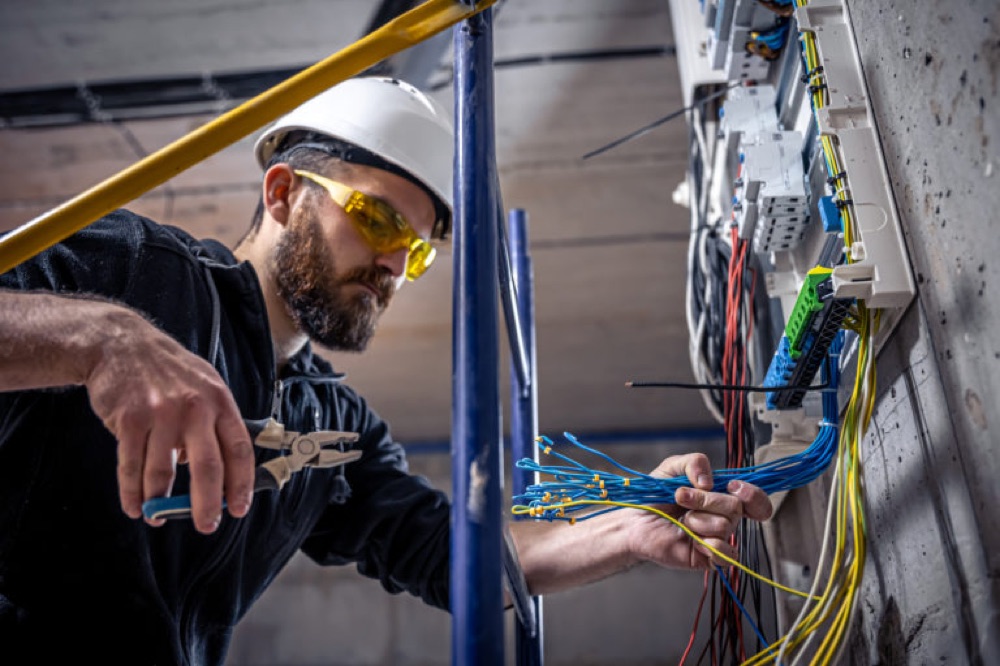 Electrician wiring a consumer unit